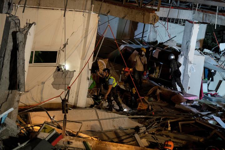 Rescue workers search for survivors in a collapsed Chuzon Super Market in Porac, Pampanga, after a powerful earthquake hit northern Philippines on April 22, 2019. 
