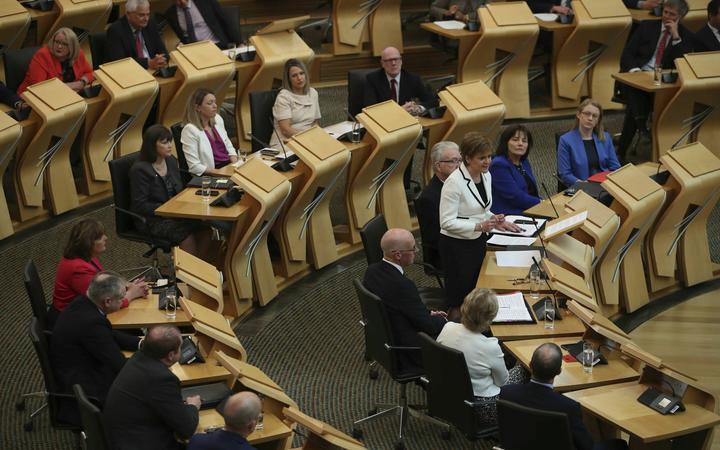First Minister of Scotland Nicola Sturgeon, standing, issues a statement on Brexit and independence in the main chamber at the Scottish Parliament, Edinburgh, Wednesday April 24, 2019. 