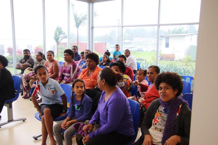 Children wait with their families to be screened at the new centre.