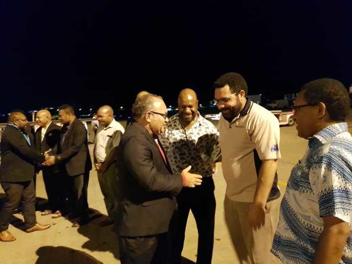 PNG Prime Minister greets supporting MPs after arriving back in the country from a visit to China.