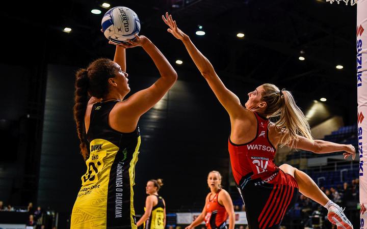 Aliyah Dunn of the Pulse shoots over Jane Watson of the Tactix. 