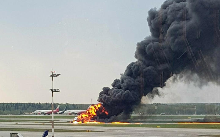 In this image provided by Riccardo Dalla Francesca shows smoke rises from a fire on a plane at Moscow's Sheremetyevo airport on Sunday, May 5, 2019. 