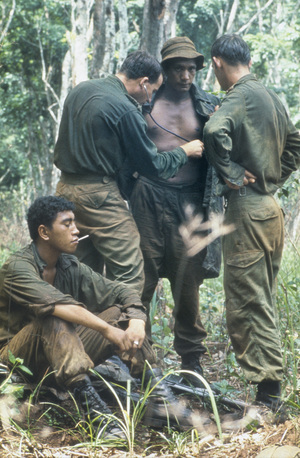 An Australian medical officer treating the New Zealand W Company during a resupply in the field during the Vietnam War. 
