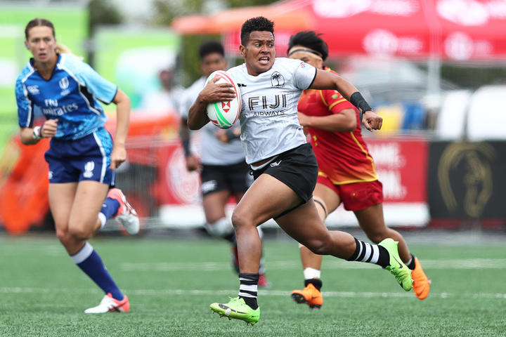 Fiji's Lavenia Tinai breaks through the Chinese defence in the Challenge Trophy final.