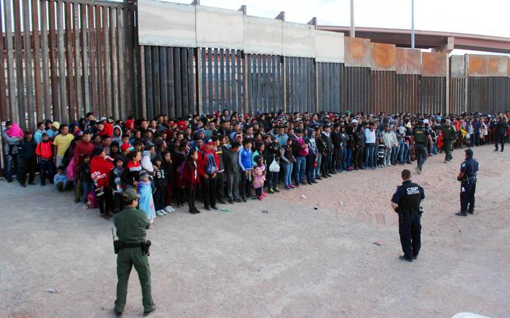 A photo released by US Customs and Border Protection shows migrants who crossed the US-Mexico border in El Paso, Texas