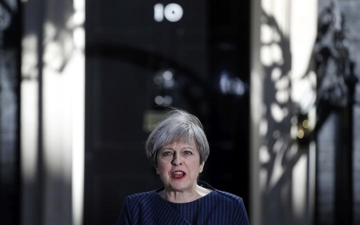 FILE - In this Tuesday, April 18, 2017 file photo, Britain's Prime Minister Theresa May arrives to speak to the media outside her official residence of 10 Downing Street in London.  