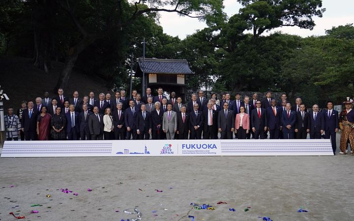 Japan's Finance Minister Taro Aso poses with delegation members during a photo of the G20 finance ministers and central bank governors meeting in Fukuoka. 