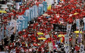 Protesters against the extradition law march along a downtown street in Hong Kong Sunday, June 9, 2019. 