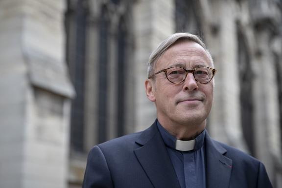 The Notre-Dame de Paris cathedral's rector Patrick Chauvet poses on June 13, 2019 in front of the cathedral which will host in three days its first mass since a fire ravaged the Paris landmark almost two months ago.
