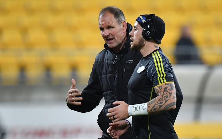 Hurricanes head coach John Plumtree speaks with TJ Perenara.