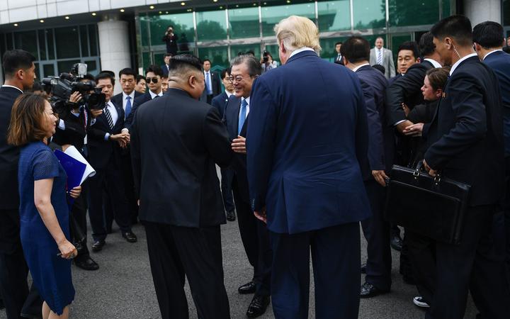 North Korea's leader Kim Jong Un (centre L) meets with South Korea's President Moon Jae-in (C) as US President Donald Trump (centre R) look on in the DMZ