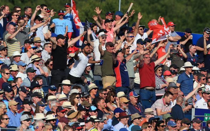 Cricket fans cheer during the 2019 Cricket World Cup group stage match between England and New Zealand at the Riverside Ground, in Chester-le-Street, northeast England