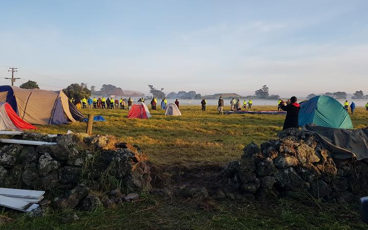 A piece of wall has been removed to allow acces to the paddocks at Ihumātao.