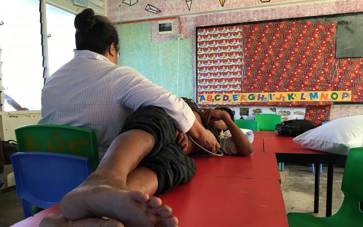 A boy being screened for rheumatic heart disease in Tuvalu