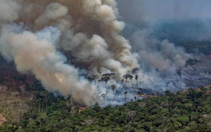 Smoke billowing from forest fires in the municipality of Candeias do Jamari, close to Porto Velho in Rondonia State, Brazil, 24 August 2019.