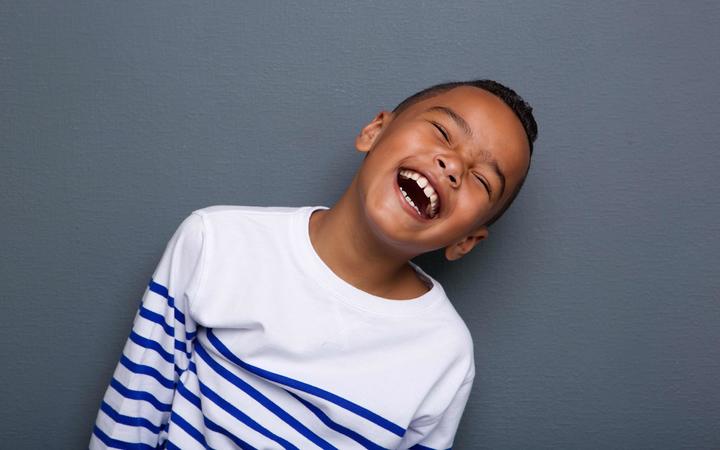 Portrait of a happy little boy laughing