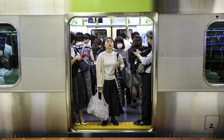 Passengers on a Tokyo subway train, July 2019.