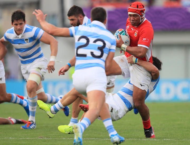 Tonga's Siale Piutau is wrapped up by the Pumas defence.