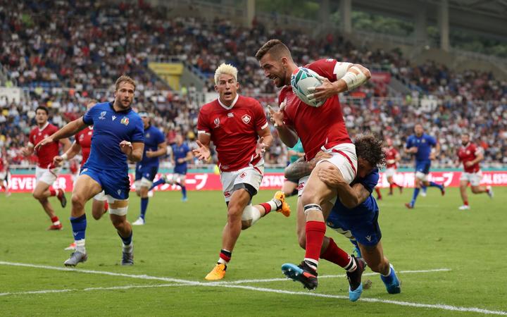 DTH Van Der Merwe screams to team-mate Patrick Parfrey to off load as he is tackled by Italy's Matteo Minozzi.
