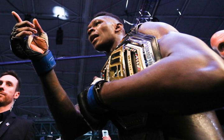 Israel Adesanya celebrates after defeating Robert Whittaker of Australia during the middleweight title bout of the UFC 243 fight night in Melbourne on October 6, 2019
