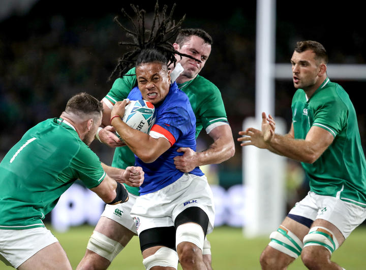 Samoa flanker TJ Ioane is wrapped up by the Irish defence.