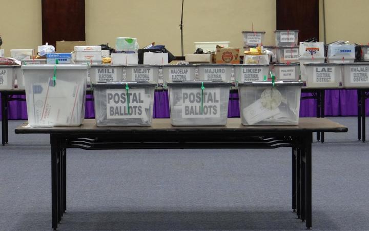 Boxes of postal absentee ballots cast in the 2015 national election await tabulation in Majuro in this file photo from 2015. 