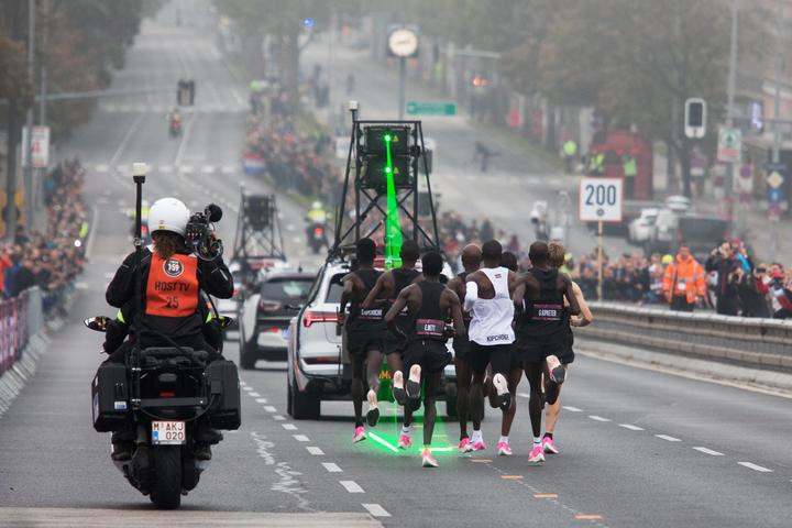 Eliud Kipchoge (white jersey), accompanied by pacemakers follow a laser beam during the Vienna marathon record. 