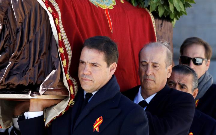 Family members Prince Louis Alphonse of Bourbon, Duke of Anjou (L) and Francis Franco (C) carry the coffin of Spanish dictator Francisco Franco out of the basilica of the Valle de los Caidos (Valley of the Fallen) mausoleum in San Lorenzo del Escorial on October 24, 2019. 