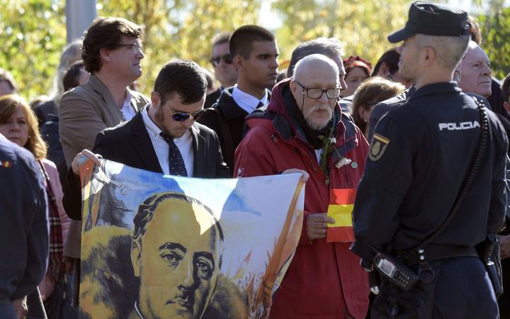 Pro-Franco supporters gather outside the cementery of Mingorrubio-El Pardo in Madrid, after the general's exhumation form the Valle de los Caidos (Valley of the Fallen) mausoleum in San Lorenzo del Escorial on October 24, 2019.