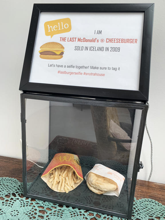A burger with a side of fries protected in a glass case, belonging to Iceland's Hjortur Smarason, is on display in the Snotra House, a hostel in Thykkvibaer, southern Iceland, on October 31, 2019. 