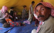 Iraqi Yazidi refugees rest inside a tent at the Newroz camp in Hasaka province, north eastern Syria.
