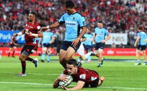 Crusaders player Will Jordan scores a try during their Super Rugby match against the New South Wales Waratahs in Nelson.