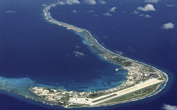 An aerial view of the southern part of Kwajalein Atoll, with the US Army's missile range headquarters island in the foreground, Ebeye Island three islands along the reef on the right side, and the pass where the Ebeye fishermen drifted out of the lagoon to the left just outside of the photo.