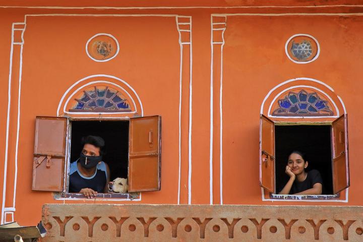Residents look out from window at walled city during the nationwide Lockdown imposed in the wake of the deadly novel coronavirus pandemic  in Jaipur, Rajasthan,India.