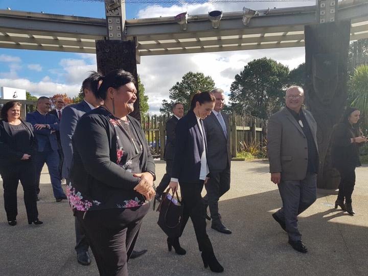 Prime Minister Jacinda Ardern, centre, walks on to Te Puia tourism centre in Rotorua. Te Puia and the Māori arts and crafts training centre will receive $7.6 million from the government to safeguard its future.