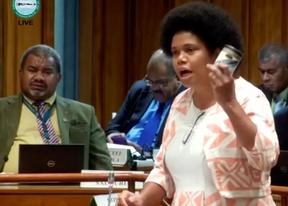 Opposition MP Lenora Qereqeretabua waves a canned fish during her address on the National Budget in Parliament.