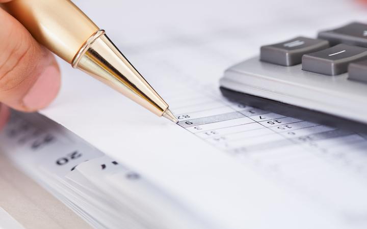 Cropped image of businessman checking expense in office