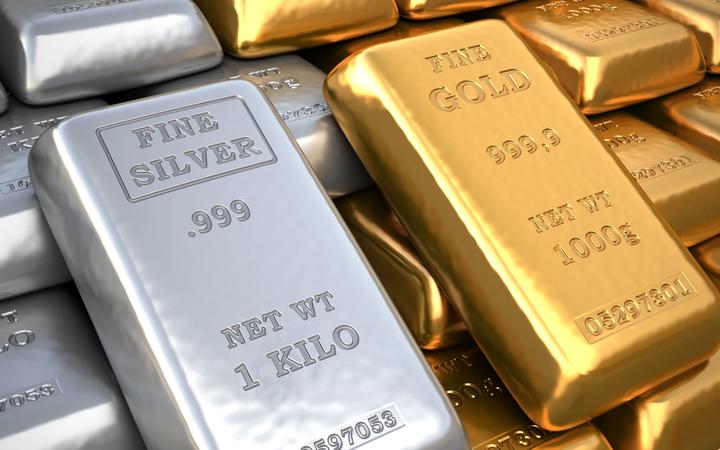 Silver ingot and gold bullion. 