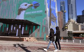 A sign in Federation Square urges people to wear a mask in the central business district in Melbourne on 6 August, 2020. 