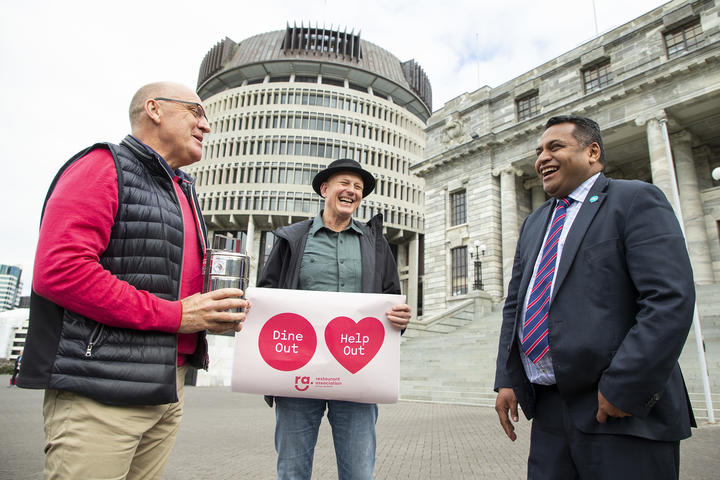 President of the Restaurant Association Mike Egan (L) and Association Vice President Steve Logan deliver lunch to Minister Kris Faafoi at Parliament.