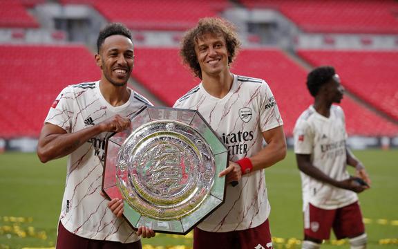 Arsenal's Gabonese striker Pierre-Emerick Aubameyang (L) and Arsenal's Brazilian defender David Luiz (R) pose with the trophy after winning the English FA Community Shield football match between Arsenal and Liverpool at Wembley Stadium in north London on August 29, 2020.