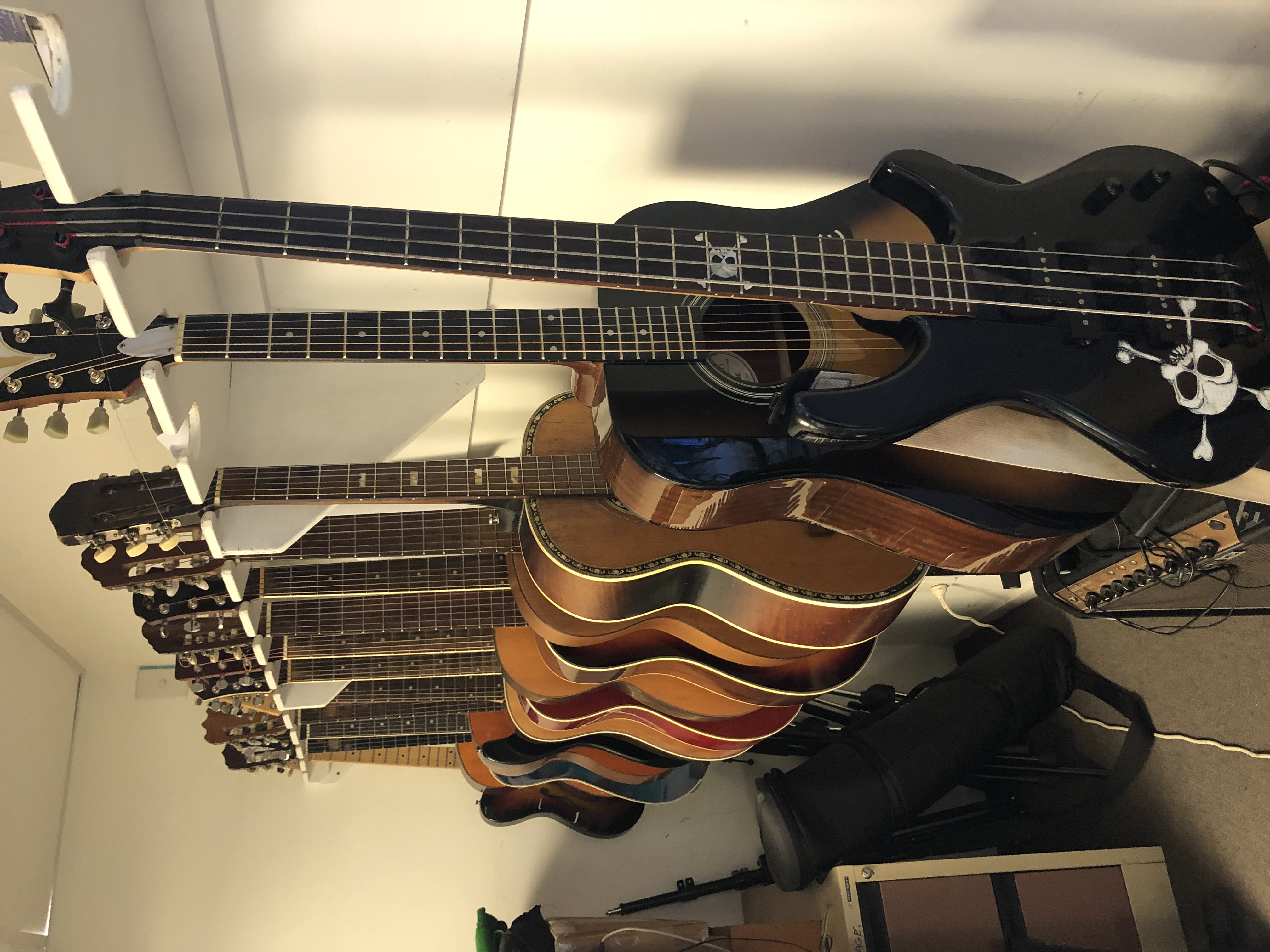 A rack of electric and acoustic guitars
