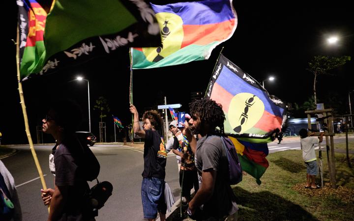 Des partisans de l'indépendance kanak brandissent des drapeaux du Front socialiste de libération nationale kanak (FLNKS) après le référendum sur l'indépendance du territoire français du Pacifique Sud de la Nouvelle-Calédonie à Nouméa le 4 octobre 2020. (Photo de Théo Rouby / AFP)