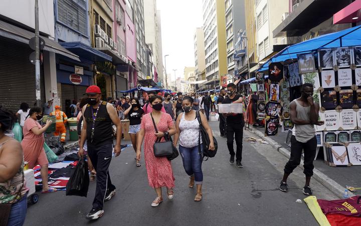 People walk at a popular shopping street amid the coronavirus disease (COVID-19) outbreak in Sao Paulo, Brazil, on October 4, 2020. 
