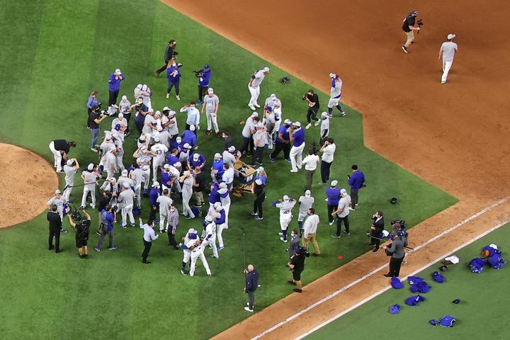 ARLINGTON, TEXAS - OCTOBER 18: The Los Angeles Dodgers celebrate their 4-3 victory against the Atlanta Braves in Game Seven of the National League Championship Series at Globe Life Field on October 18, 2020 in Arlington, Texas.   Ronald Martinez/Getty Images/AFP