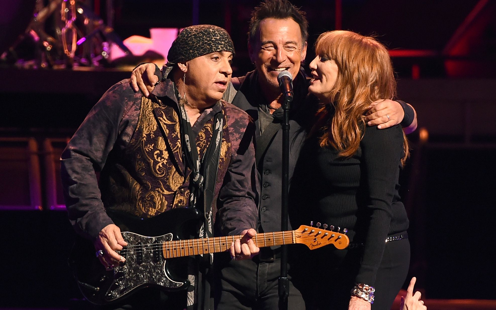 Springsteen embraces two members of the E Street Band