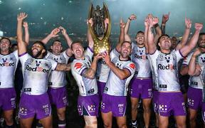 The Melbourne Storm lift the 2020 NRL Premiership trophy aloft after beating the Penrith Panthers 26-20 in the grand final in Sydney.