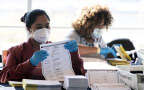 ATLANTA, GA - NOVEMBER 04: Election workers count Fulton County ballots at State Farm Arena on November 4, 2020 in Atlanta, Georgia. The 2020 presidential race between incumbent U.S. President Donald Trump and Democratic nominee Joe Biden is still too close to call 