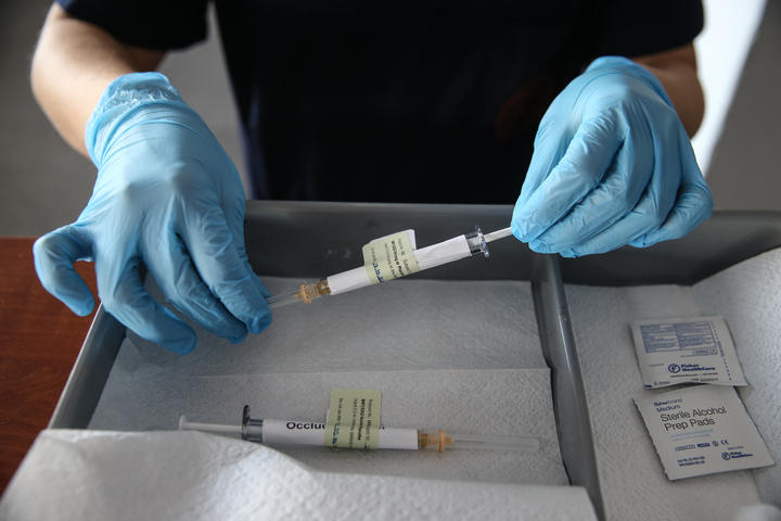 A health care worker holds an injection syringe of the phase 3 vaccine trial, developed against the novel coronavirus pandemic by the US Pfizer and German BioNTech company, at the Ankara University Ibni Sina Hospital in Ankara, Turkey on October 27, 2020. 