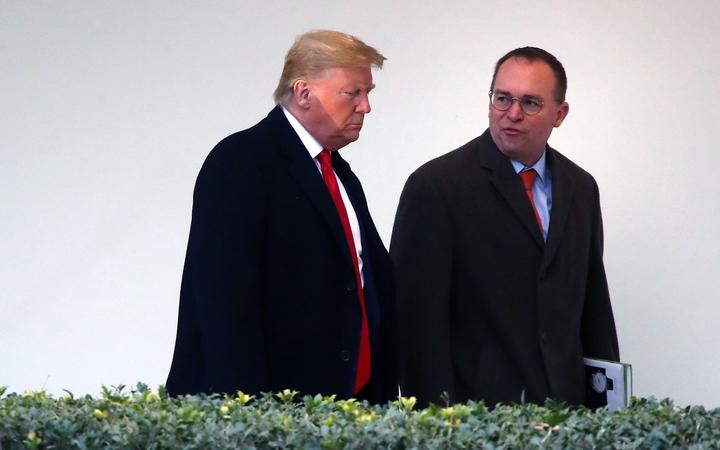 US President Donald Trump walks along the West Wing Colonnade with acting White House chief of staff, Mick Mulvaney in January 13, 2020 in Washington, DC. 